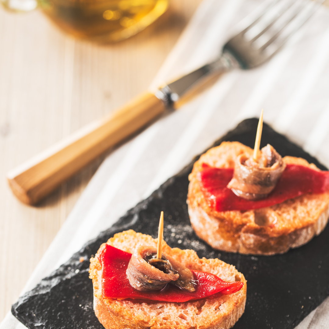 fresh anchovies tapa with piquillo pepper, oil and bread